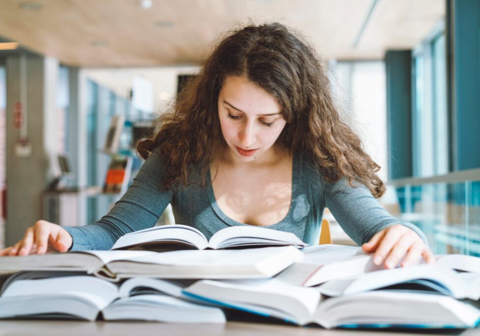 Young student learning in the library